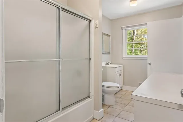 a bathroom with a toilet and a shower