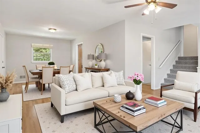 a living room with furniture a rug and a chandelier