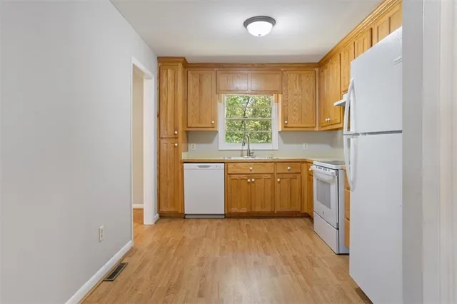 a view of a kitchen with a stove top oven