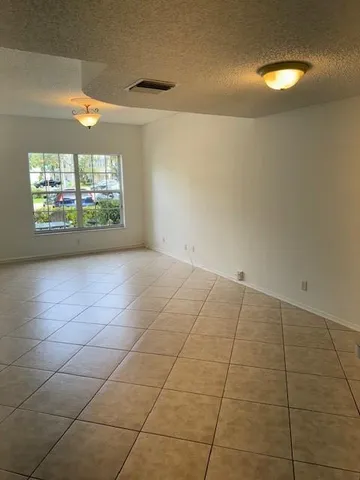 an empty room with a bathroom and a window