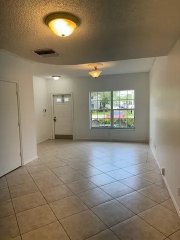 a kitchen with granite countertop a sink stove and cabinets