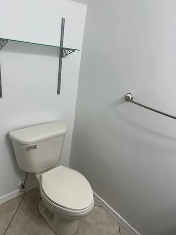 a view of staircase with white walls and a window