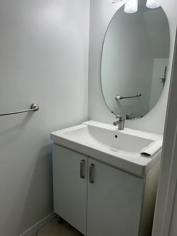 a white toilet sitting next to a shower