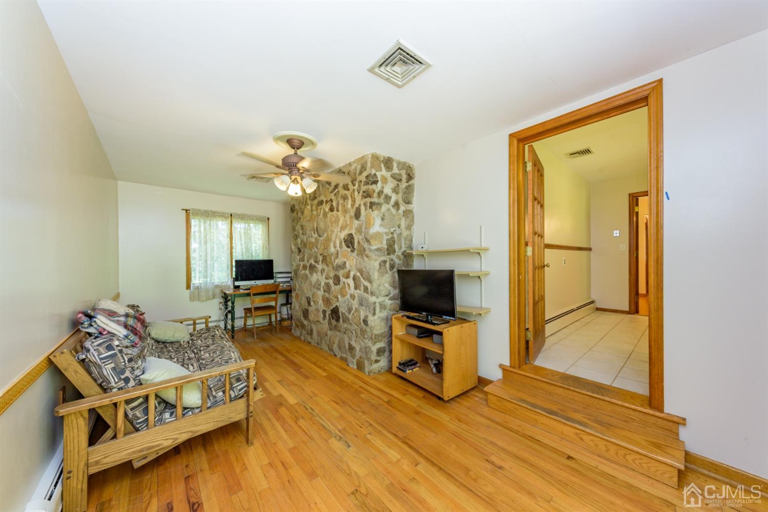 363 Rockport Road Port Murray, NJ 07865 - Photo 12 of 23 a living room with furniture a flat screen tv and a fireplace
