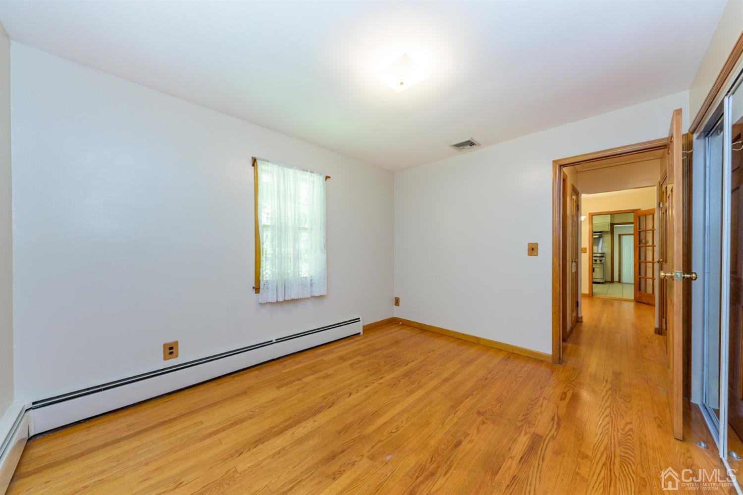 363 Rockport Road Port Murray, NJ 07865 - Photo 18 of 23 a view of empty room with wooden floor and fan