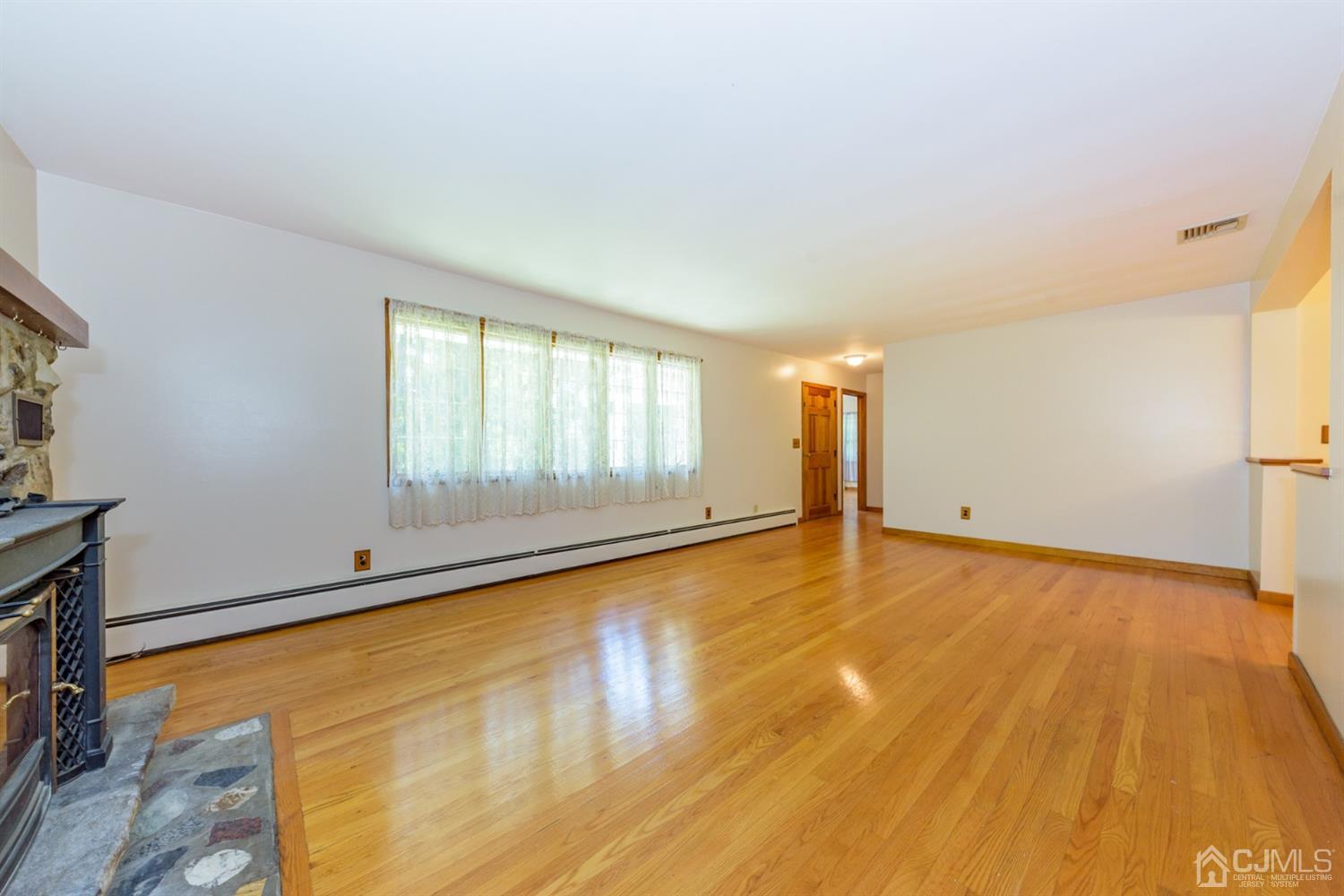 363 Rockport Road Port Murray, NJ 07865 - Photo 5 of 23 a view of an empty room with a window and wooden floor