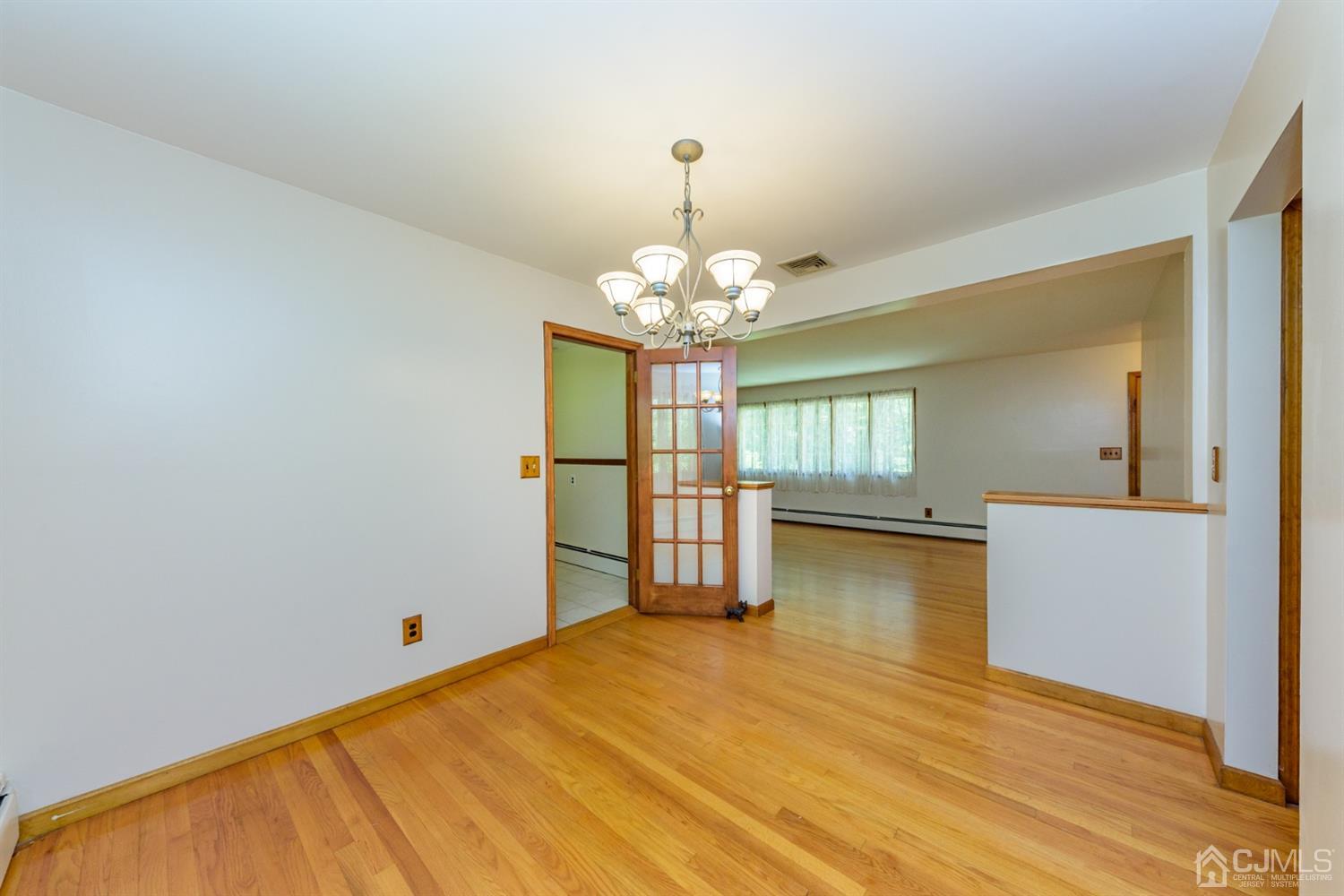 363 Rockport Road Port Murray, NJ 07865 - Photo 7 of 23 a very nice looking room with wooden floor and chandelier