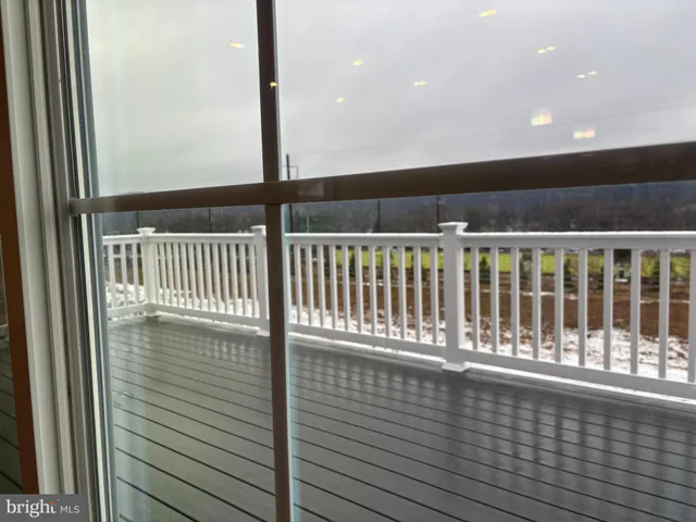 a view of balcony with wooden floor