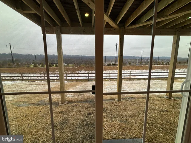 a view of a glass door with a floor to ceiling window next to a yard