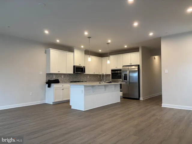 a kitchen with refrigerator and microwave