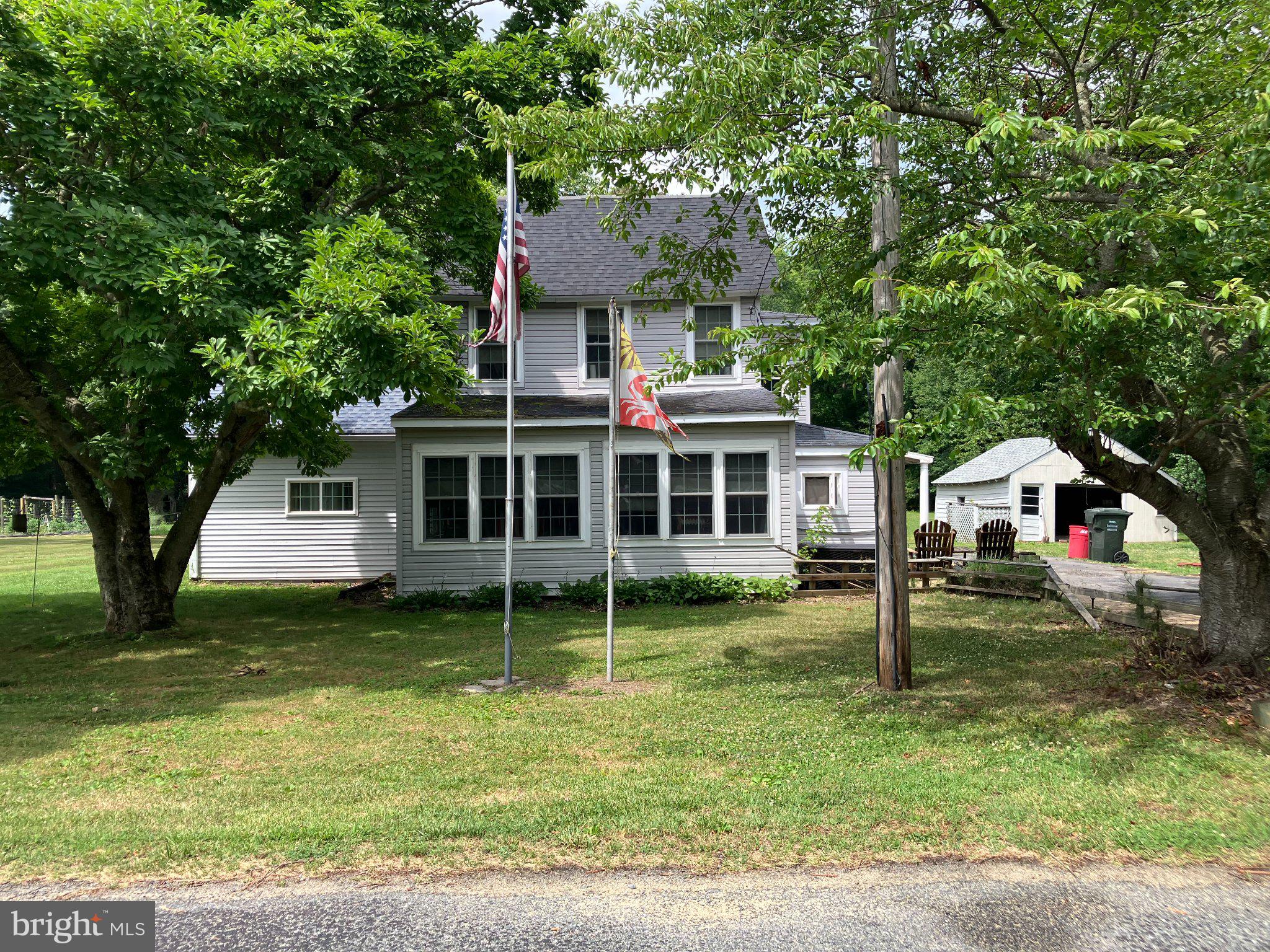 4818 Piney Neck Road Rock Hall, MD 21661 - Photo 2 of 3 Charming home with lush greenery.