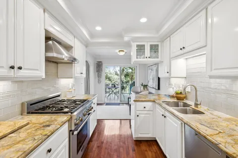 a kitchen with a sink stove and cabinets