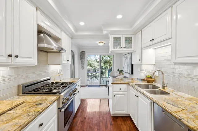 a kitchen with a sink stove and cabinets