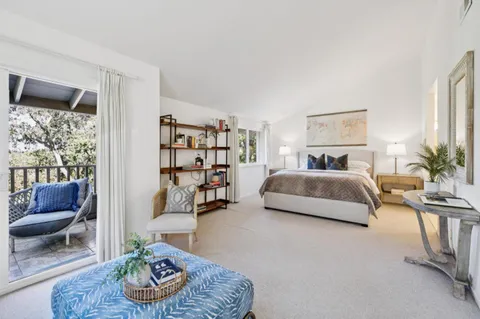 a bedroom with a bed and a couch