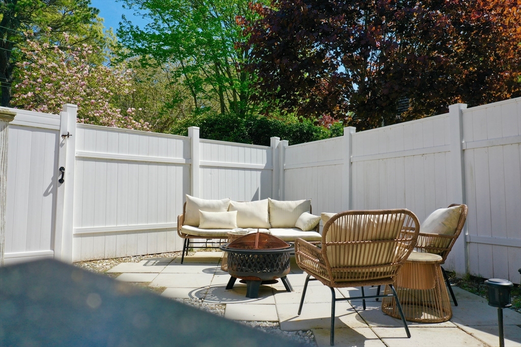 155 Great Marsh Road Centerville, MA 02632 - Photo 4 of 36 a backyard of a house with table and chairs