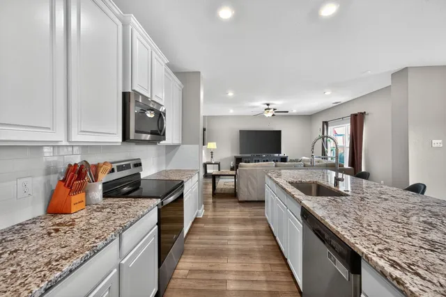 a large kitchen with granite countertop lots of counter top space