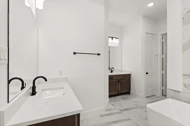 a spacious bathroom with a sink and a mirror