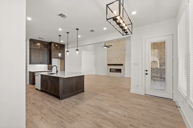 a view of kitchen with sink and refrigerator