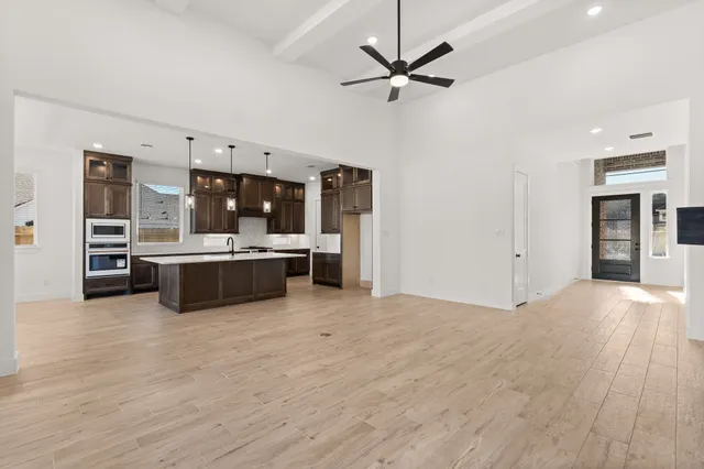 a view of a kitchen with stainless steel appliances kitchen island a sink and dishwasher