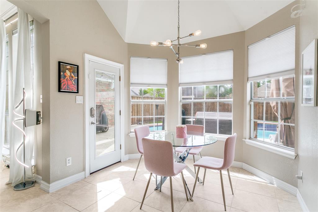 1509 Blue Mesa Road Carrollton, TX 75007 - Photo 15 of 35 a dining room with furniture a chandelier and window