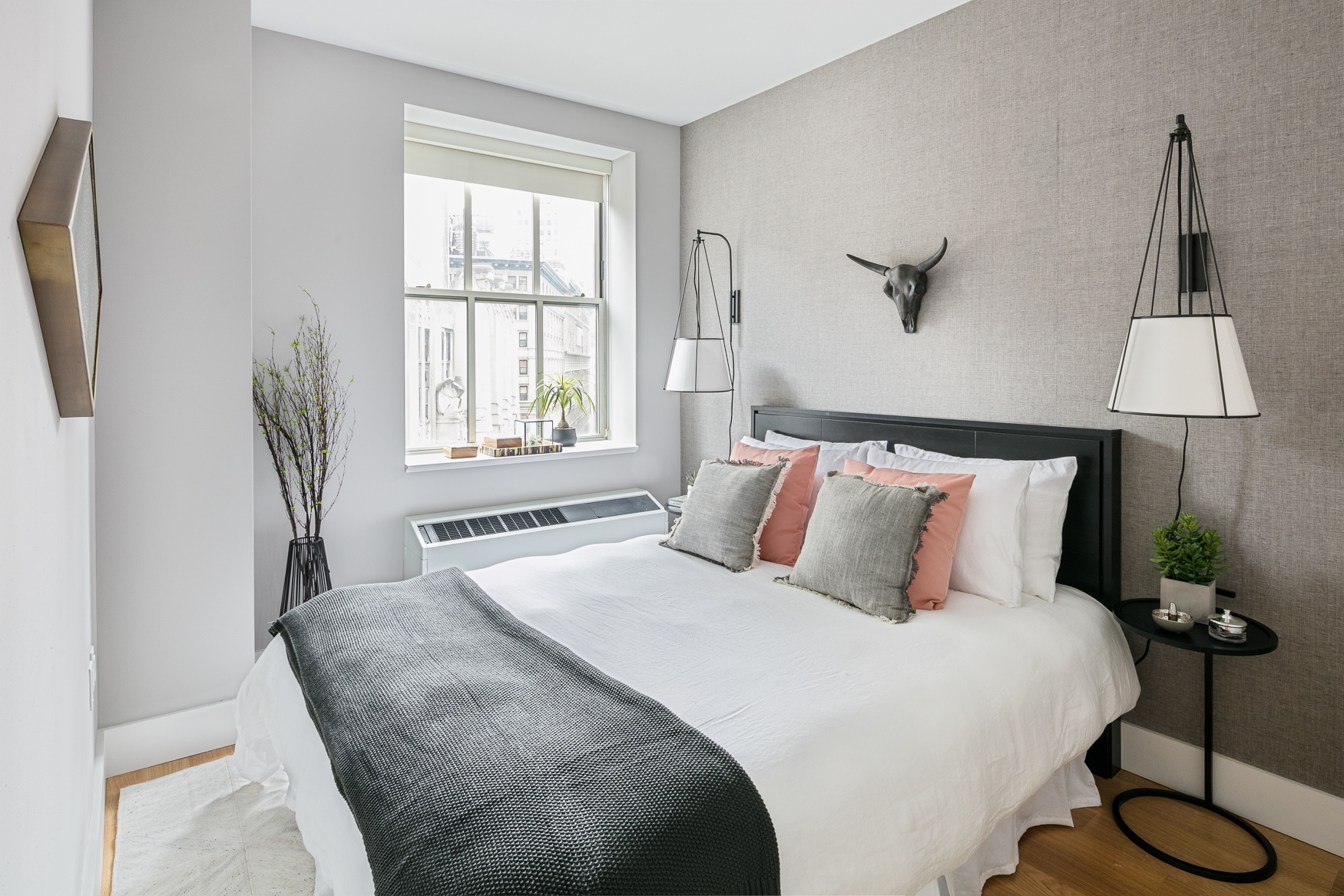 67 Wall Street, Unit 18H Manhattan, NY 10005 - Photo 2 of 20 a bedroom with a bed and a window