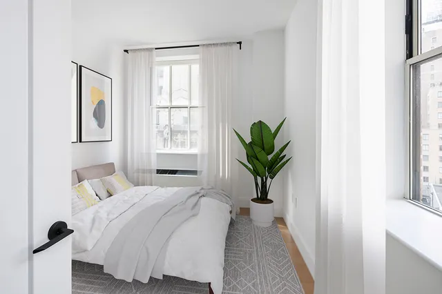 a bedroom with a bed running cycle and a window