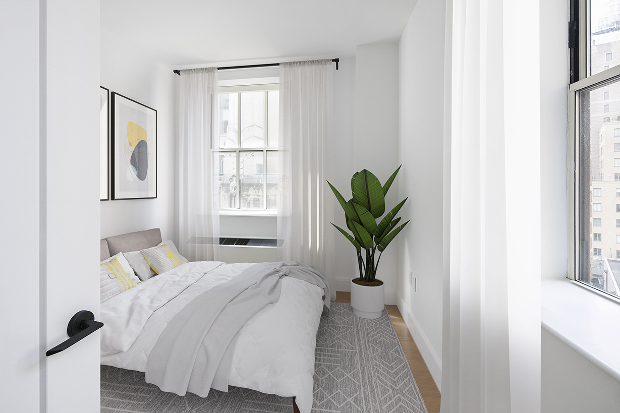 67 Wall Street, Unit 18H Manhattan, NY 10005 - Photo 3 of 20 a bedroom with a bed running cycle and a window