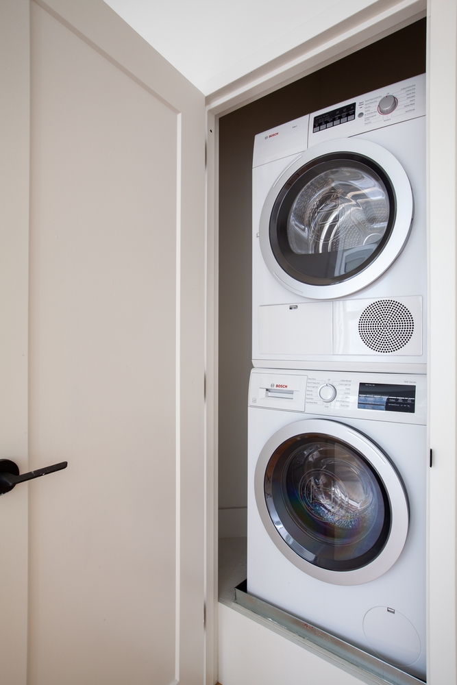 67 Wall Street, Unit 18H Manhattan, NY 10005 - Photo 7 of 20 a utility room with dryer and washer