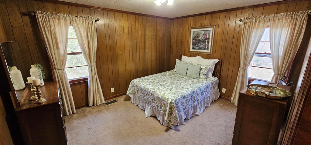 6656 Fires Creek Road Hayesville, NC 28904 - Photo 11 of 38 a bedroom with a bed next to a window
