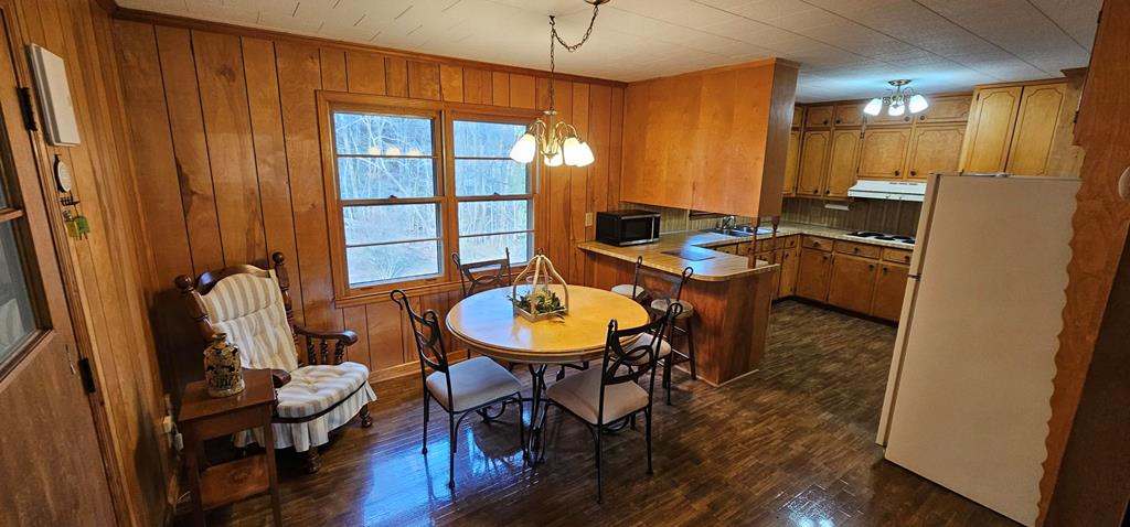 6656 Fires Creek Road Hayesville, NC 28904 - Photo 21 of 38 a view of a dining room with furniture window and wooden floor