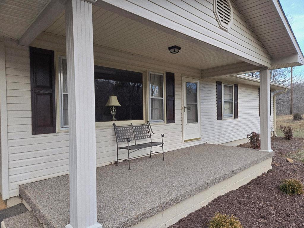 6656 Fires Creek Road Hayesville, NC 28904 - Photo 27 of 38 a view of a patio with table and chairs and wooden fence