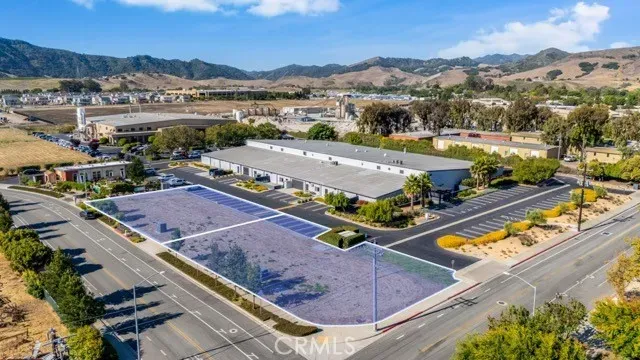 an aerial view of a resort with a mountain