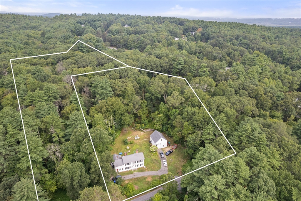 68 Spring Street Hopkinton, MA 01748 - Photo 1 of 28 a view of a forest from a balcony