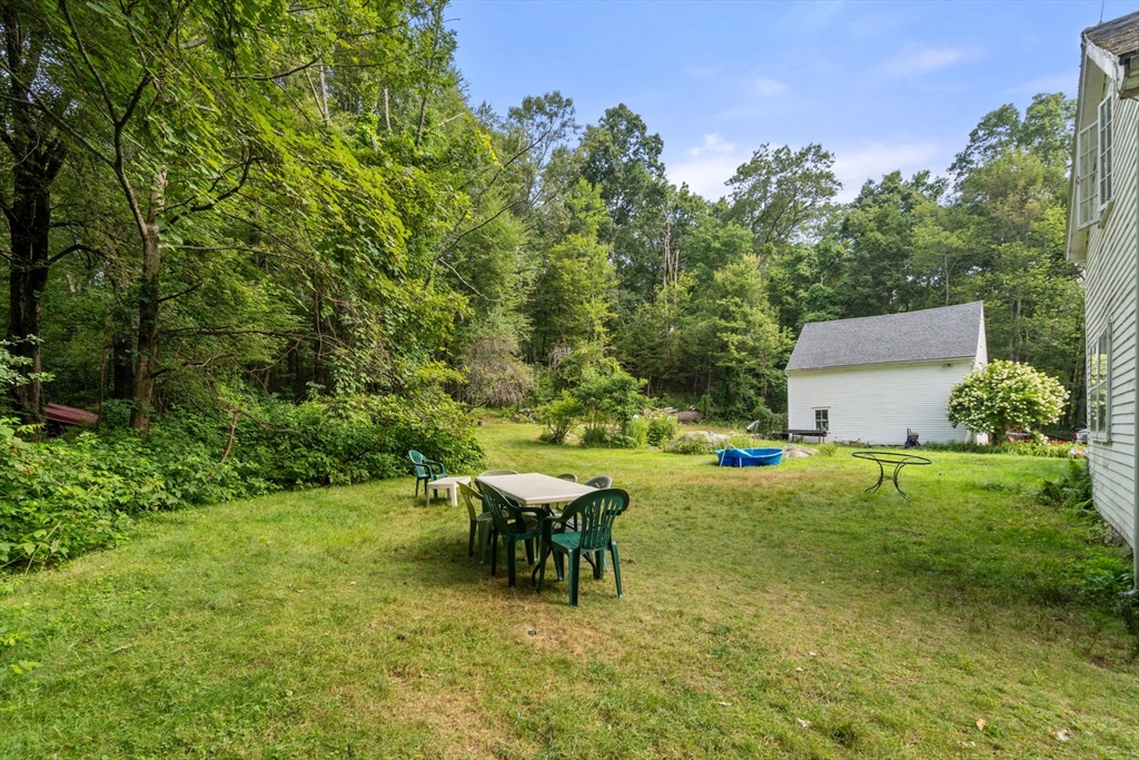 68 Spring Street Hopkinton, MA 01748 - Photo 19 of 28 a backyard of a house with table and chairs