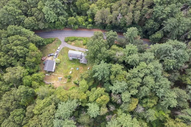 an aerial view of a house with a yard
