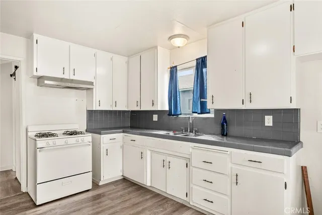 a kitchen with cabinets appliances and a window