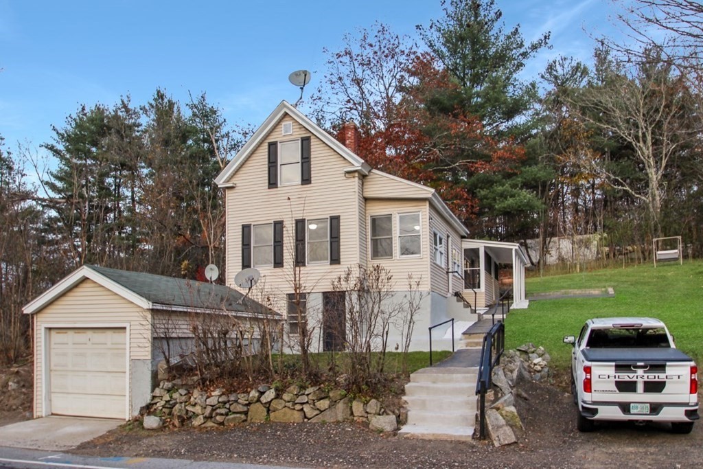 413 Mammoth Road Dracut, MA 01826 - Photo 1 of 12 a car parked in front of a house