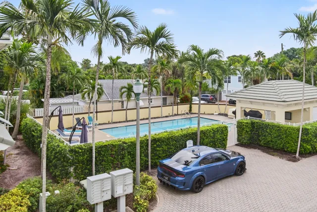 a backyard of a house with a garden and outdoor seating