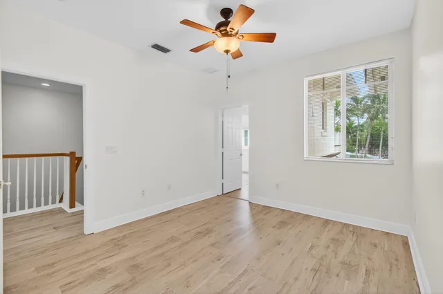 a front view of a house with a yard and potted plants