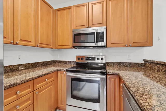 a kitchen with microwave cabinets and stainless steel appliances