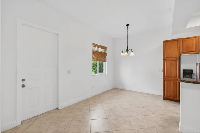 a bathroom with a granite countertop toilet sink and mirror