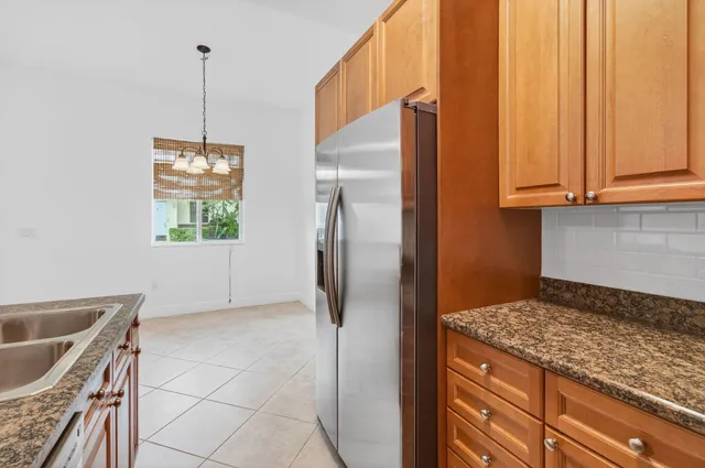 a kitchen with kitchen island a counter top space appliances and cabinets