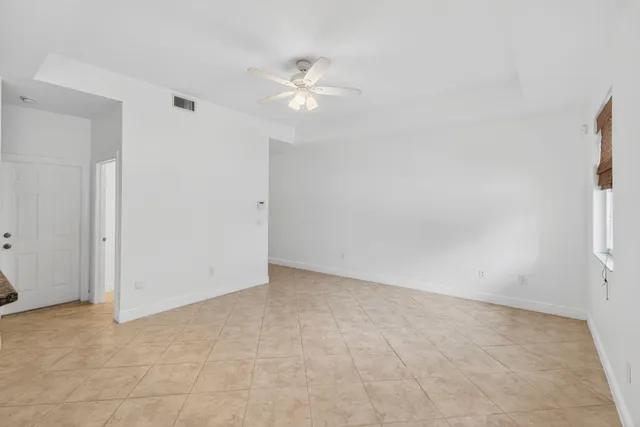 a bathroom with a granite countertop sink a toilet and mirror