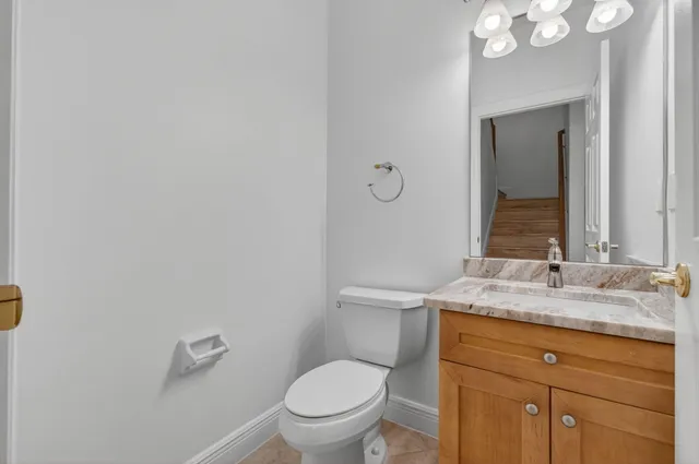 a view of empty room with wooden floor and ceiling fan