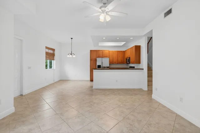 a view of a kitchen with a sink and cabinets