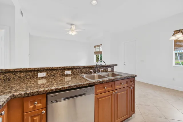 a kitchen with granite countertop a sink and cabinets