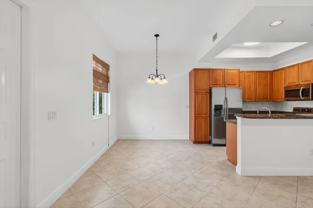 a view of kitchen with refrigerator and window