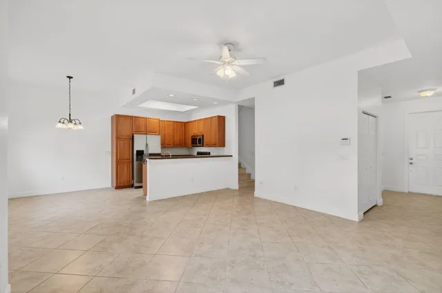 a bathroom with a granite countertop double vanity sink a mirror and a shower