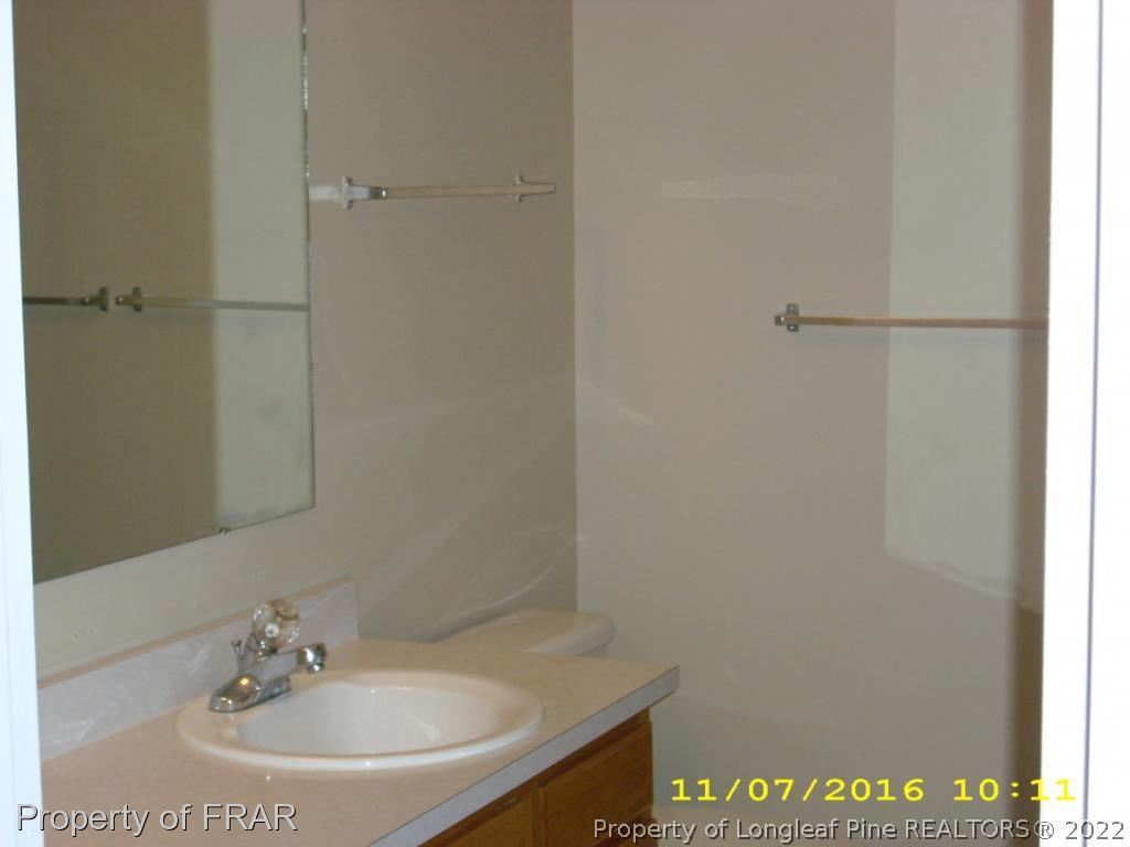 1820-2 Sardonyx Road Fayetteville, NC 28303 - Photo 13 of 21 a bathroom with a sink and a mirror