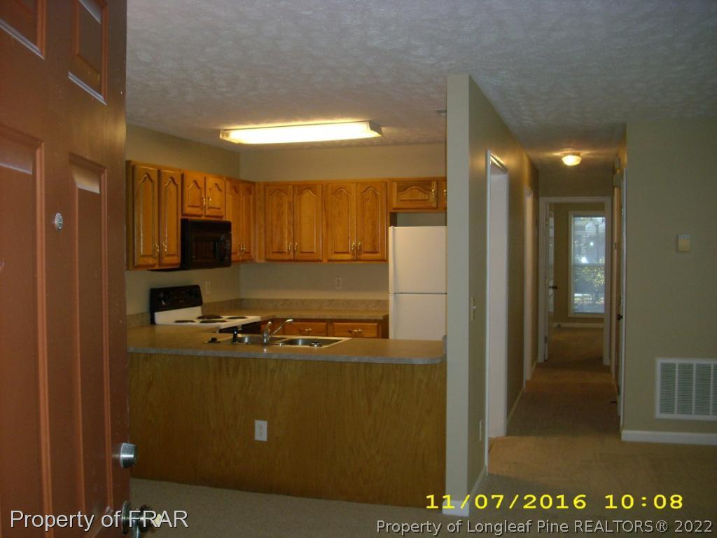 1820-2 Sardonyx Road Fayetteville, NC 28303 - Photo 5 of 21 a kitchen with stainless steel appliances granite countertop a refrigerator a stove and a sink